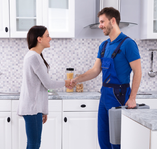 Customer shaking hands with plumber