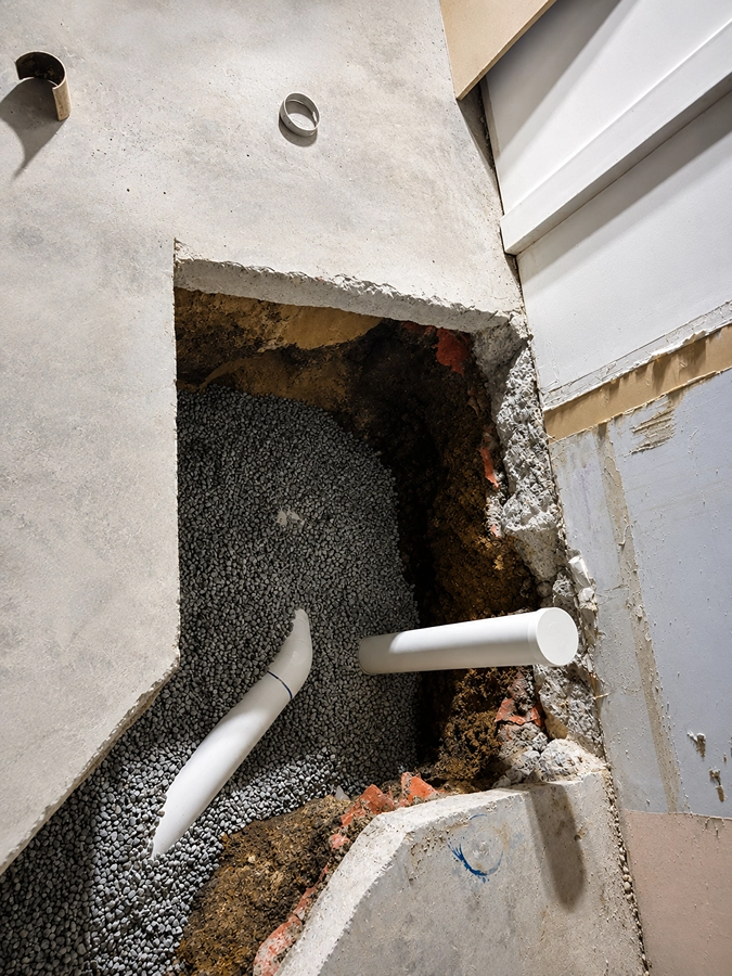 A drain repair through an opened slab, leak detection Ermington